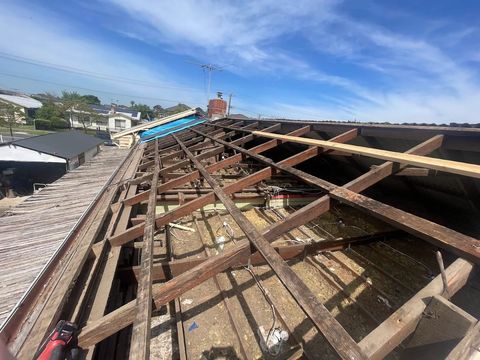 Old roof stripped back to the battens